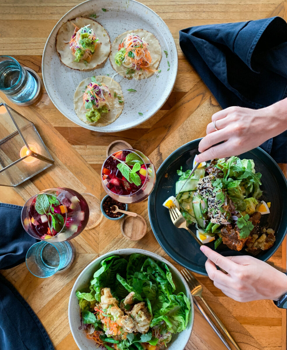 View from above showing various plates and glases with delicious food.